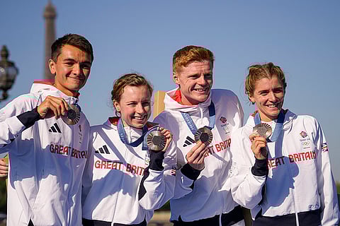 Mixed relay triathlon: Bronze medalists of Britain's Alex Yee, left, Georgia Taylor-Brown, Samuel Dickinson, and Beth Potter